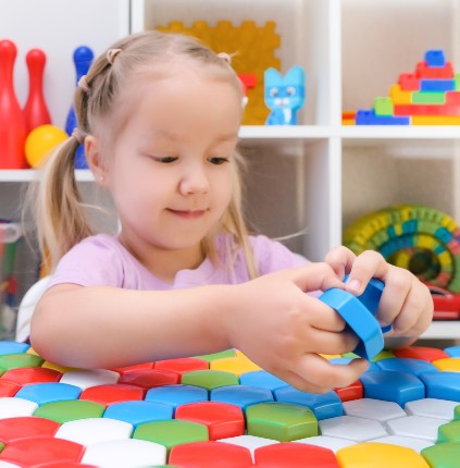 speech therapy development fine motor skills girl playing puzzle happy child 1