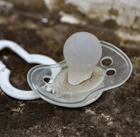 dirty silicone pacifier lying ground 1